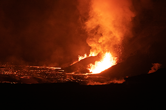 Night-time view of the eruption and pool of lava in Halemaumau Crater as seen from the Crater Rim Trail (after dark). (Zoom view)